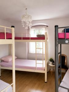 a room with two bunk beds with a chandelier at Guest House Elizabeta in Split