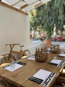 a wooden table with napkins and baskets on it at Almond Chambers in Naousa