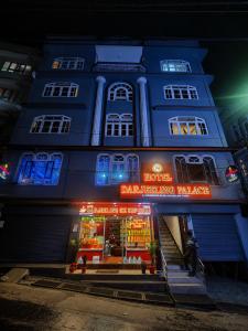 a blue building with a store in front at night at Hotel Darjeeling palace in Darjeeling