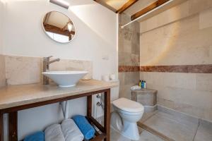 a bathroom with a sink and a toilet at Kabak Avalon Bungalows in Faralya +55 photos