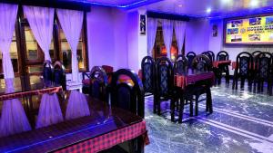 a row of tables and chairs in a restaurant at Hotel Darjeeling palace in Darjeeling