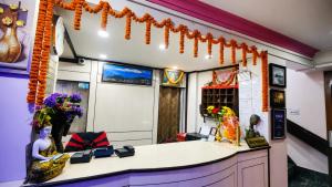 an office with a reception desk with orange garland at Hotel Darjeeling palace in Darjeeling +21 photos