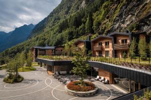 a view of a resort with a mountain at LVG Hotel Collection - Cascata d'Otro Mountain Lodge in Alagna Valsesia