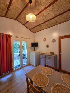 a dining room with a table and a refrigerator at Chalet tout confort in Rivières