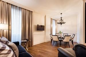 a living room with a dining room table with chairs at Hotel Milano & SPA***S in Verona