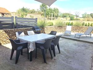 a table and chairs sitting on a patio at Le Galaveyson in Saint-Clair-sur-Galaure