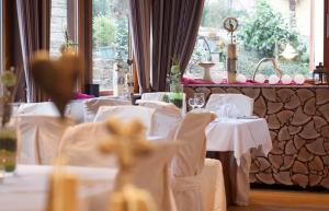a dining room with white tables and white chairs at Hotel- Restaurant Poststuben in Bensheim
