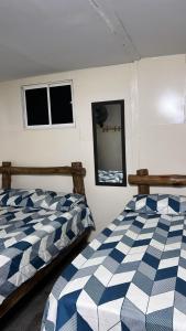 a bedroom with two beds and two windows at Venido del mar beach in Cartagena de Indias