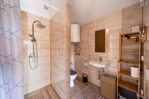 a bathroom with a shower and a toilet and a sink at Mazurski domek in Mrągowo +20 photos