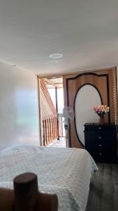 a bedroom with a bed and a large mirror at Venido del mar beach in Cartagena de Indias