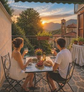 a man and woman sitting at a table with wine glasses at San Marco Panorama Apartment in Torre deʼ Busi +18 photos
