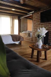 a living room with a couch and a table with flowers at Mount House Lodge in Guano