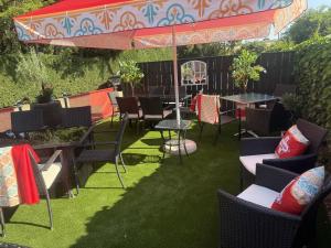 a patio with chairs and tables and an umbrella at The Blue Bell Inn in Weaverthorpe