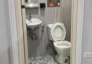 a bathroom with a toilet and a sink at Amplayo Apartelle 2-BR Unit in Cagayan de Oro +61 photos