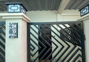 a gate in a building with a clock on it at Amplayo Apartelle 2-BR Unit in Cagayan de Oro