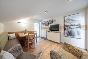 a living room with a kitchen and a dining room at Garni Ötztal ROOMS & APARTS in Sölden