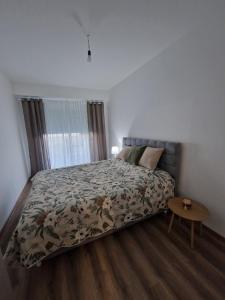 a bedroom with a bed and a table in it at Apartment Dalas 2 Star Dojran in Star Dojran