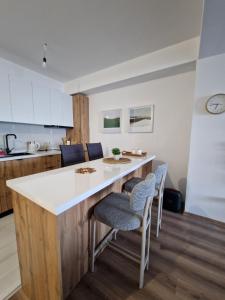 a kitchen with a large white island in a room at Apartment Dalas 2 Star Dojran in Star Dojran +7 photos