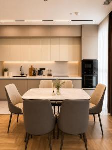 a kitchen with a dining room table and chairs at NestOne - Apartment hotels in Tashkent