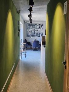 an office with a hallway with a table and chairs at Winnica Tenczyn in Grojec