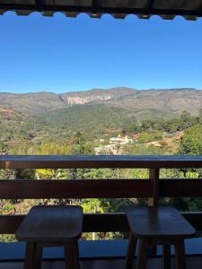 a view of the mountains from the balcony of a house at Vila Literária Tabuleiro in Conceição do Mato Dentro