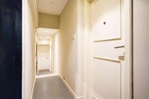 a hallway with a door leading to a closet at Hotel O Siba Inn in Mumbai