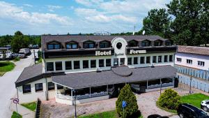 a hotel building with a sign on top of it at Hotel Ferum in Šaca