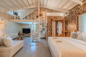 a bedroom with a loft bed and a living room at Oikies Small Elegant Houses in Mytilene +66 photos