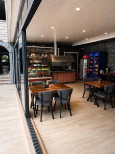 a restaurant with wooden tables and chairs and a counter at Butik İsabel Otel in Kemer