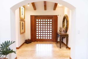 an archway leading to a door in a room at BUHO Luxury Guayllabamba Home BBQ Jacuzzi Pool in Quito