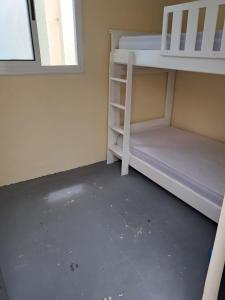 a room with two bunk beds and a window at casa celia in Asilah +1 photo