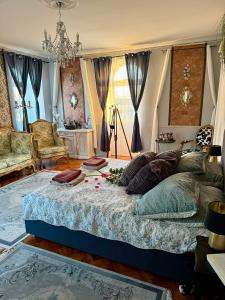 a bedroom with a large bed with pillows on it at Chateau Vincze in Sátoraljaújhely +39 photos
