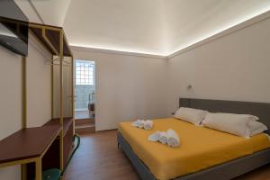 a bedroom with a bed with two towels on it at Design Apartment in Monopoli