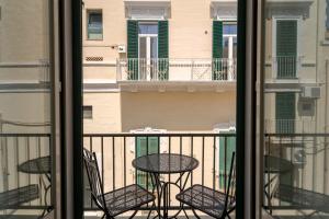 a balcony with chairs and a table on a balcony at Design Apartment in Monopoli