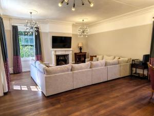 a living room with a couch and a fireplace at Bardon Hill Manor in Coalville