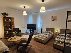 a living room with a bed and a couch at Studio Hálkova in Chlumec nad Cidlinou