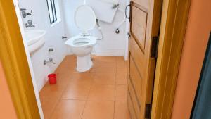 a bathroom with a toilet and a sink at new crown hotel in Indore