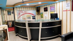 a lobby with a counter with a computer on it at new crown hotel in Indore