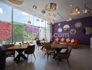 a restaurant with tables and chairs and a couch at HS HOTSSON Hotel Queretaro in Querétaro