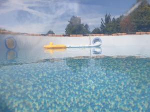 a pool of water with a yellow tube in the water at Normandieheritage14 Moulin de la Bretonnière - OMAHA BEACH DDAY Tour Guide E-bike in Aignerville