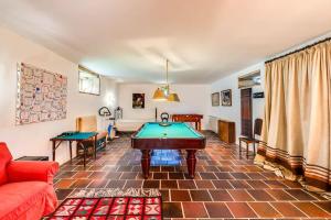 a living room with a pool table in it at Portugal Active Oliveiras Farm in Viana do Castelo
