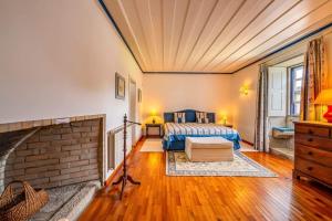 a bedroom with a bed and a brick fireplace at Portugal Active Oliveiras Farm in Viana do Castelo