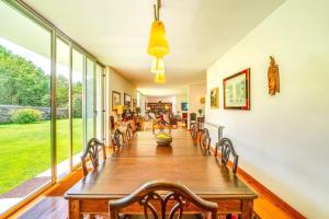a large dining room with a long table and chairs at Portugal Active Oliveiras Farm in Viana do Castelo +65 photos