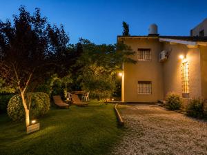a yard with a house at night with lights at Tierra Mora Casas de alquiler in Villa Gesell