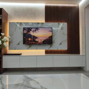a living room with a tv on a wall at PIT STOP B&B Guesthouse in Urtsʼadzor