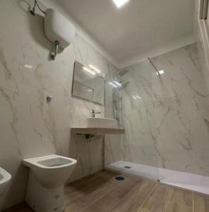 a white bathroom with a toilet and a sink at B&b Antonia in SantʼAntonio Abate