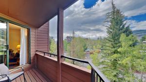 a balcony with a view of a pine tree at 135 Marina Place in Dillon