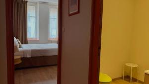 a room with a bedroom with a bed and a window at Logis-Hôtel des Oliviers in Thionville