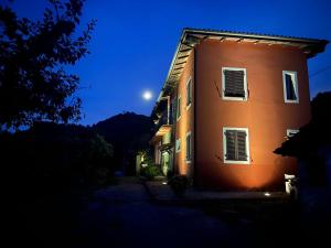a building at night with the moon in the sky at Cà del Prino in Millesimo