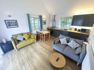 a living room with a couch and a table at Willoughby Lodges in Blagdon